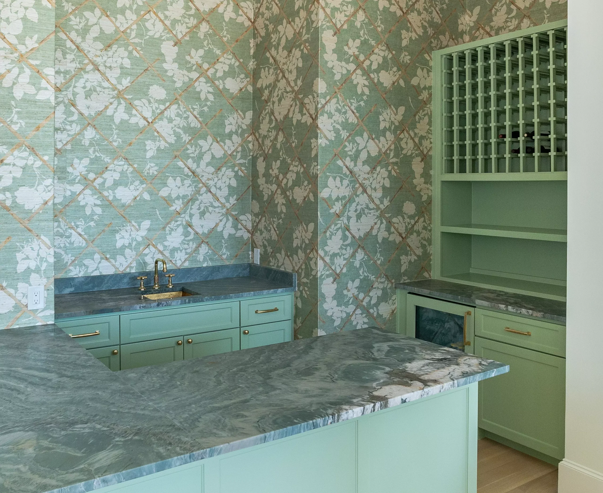 Home bar featuring a Rio Fantastico Quartz countertop, mint green cabinetry, and floral wallpaper