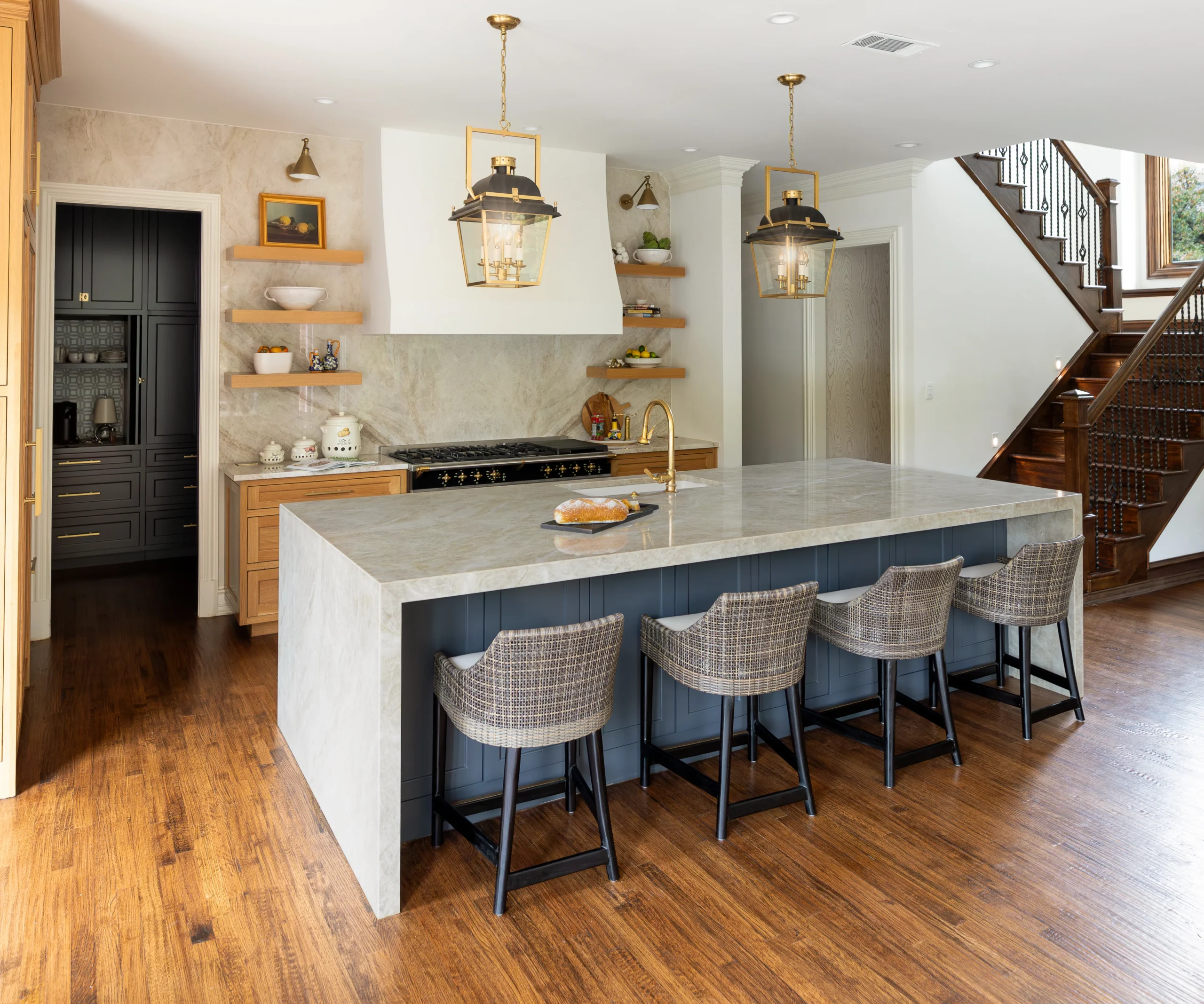 Modern kitchen with Waterfall Center Island made of Taj Mahal quartzite, featuring elegant design and premium countertops