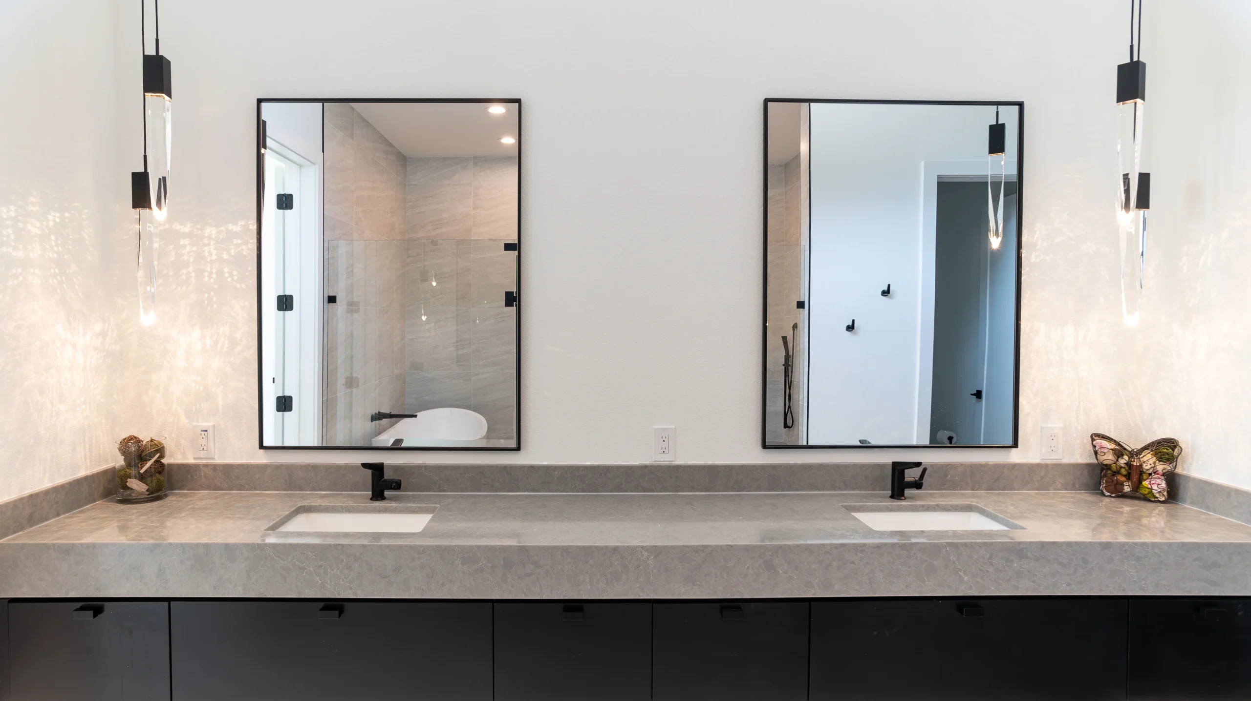 Contemporary bathroom with a Maestro Marble countertop, black cabinetry, and modern mirrors, designed and fabricated by Allied Gallery