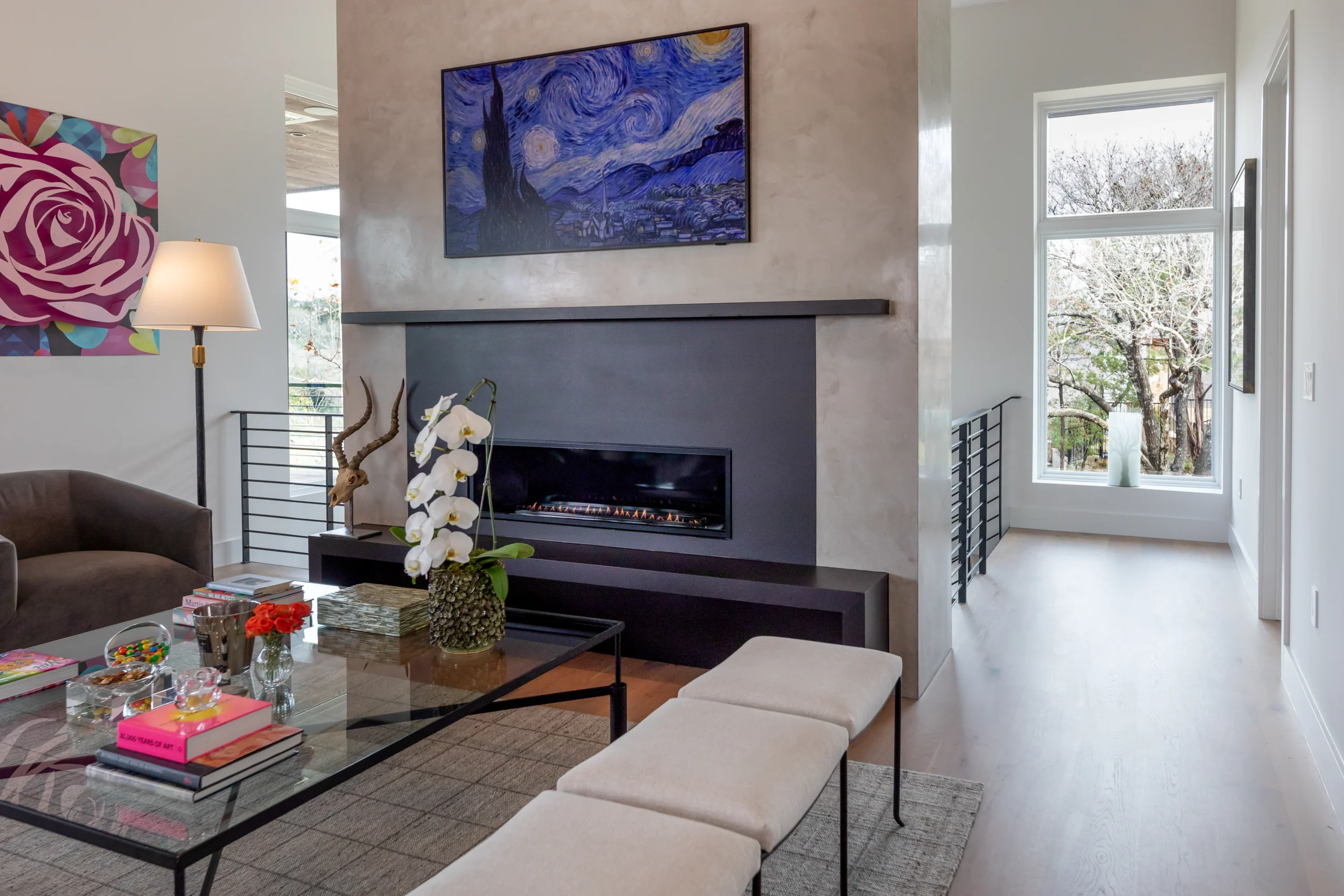 Modern living room with a natural stone fireplace, featuring a sleek gas insert, contemporary art, and stylish furnishings, designed and fabricated by Allied Gallery Austin