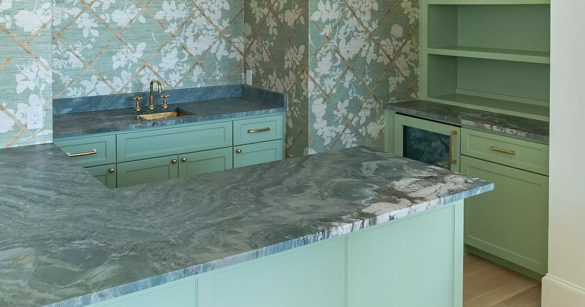 Blog Banner Image Home bar featuring Rio Fantastico Quartzite Honed countertops from Brazil, complemented by pastel green cabinetry and floral wallpaper